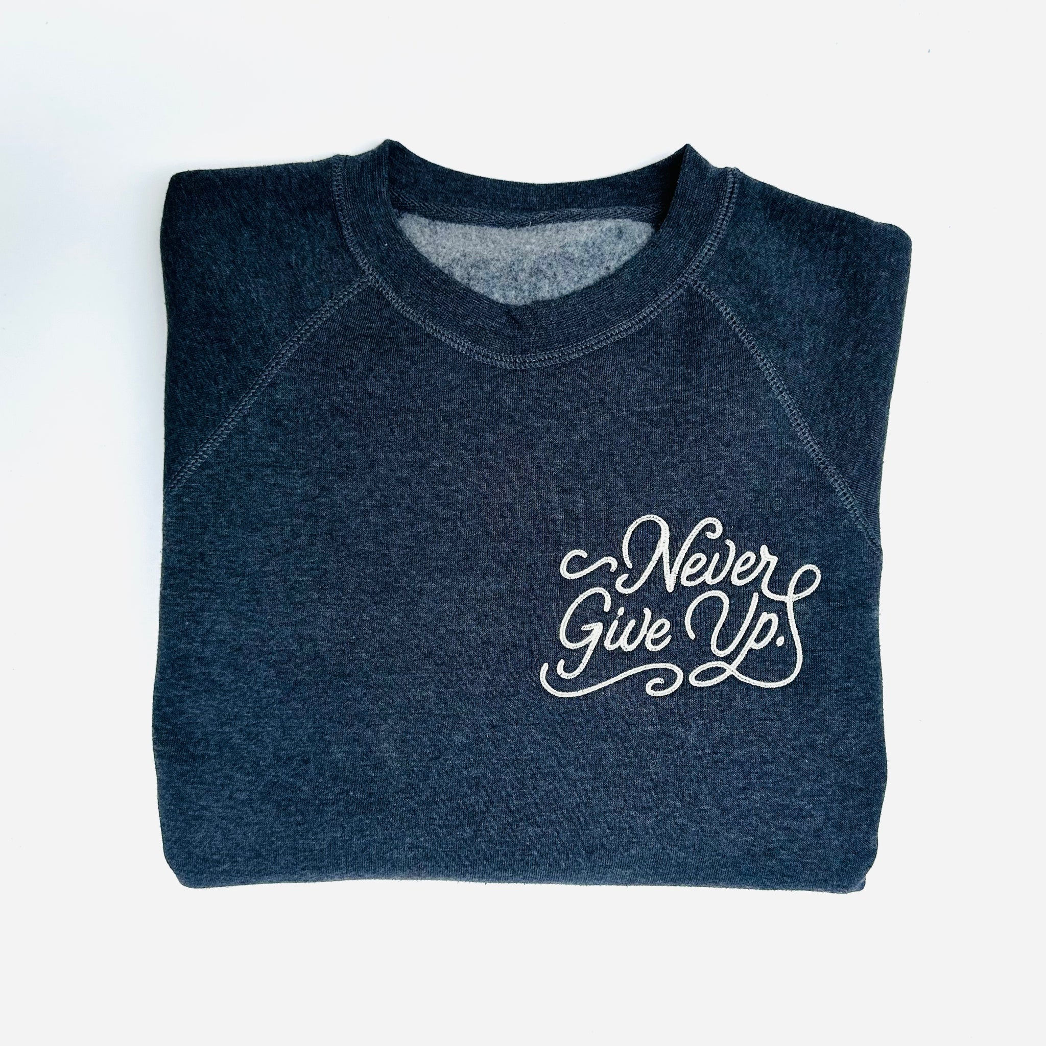 EMBROIDERED NEVER GIVE UP. NAVY PULLOVER