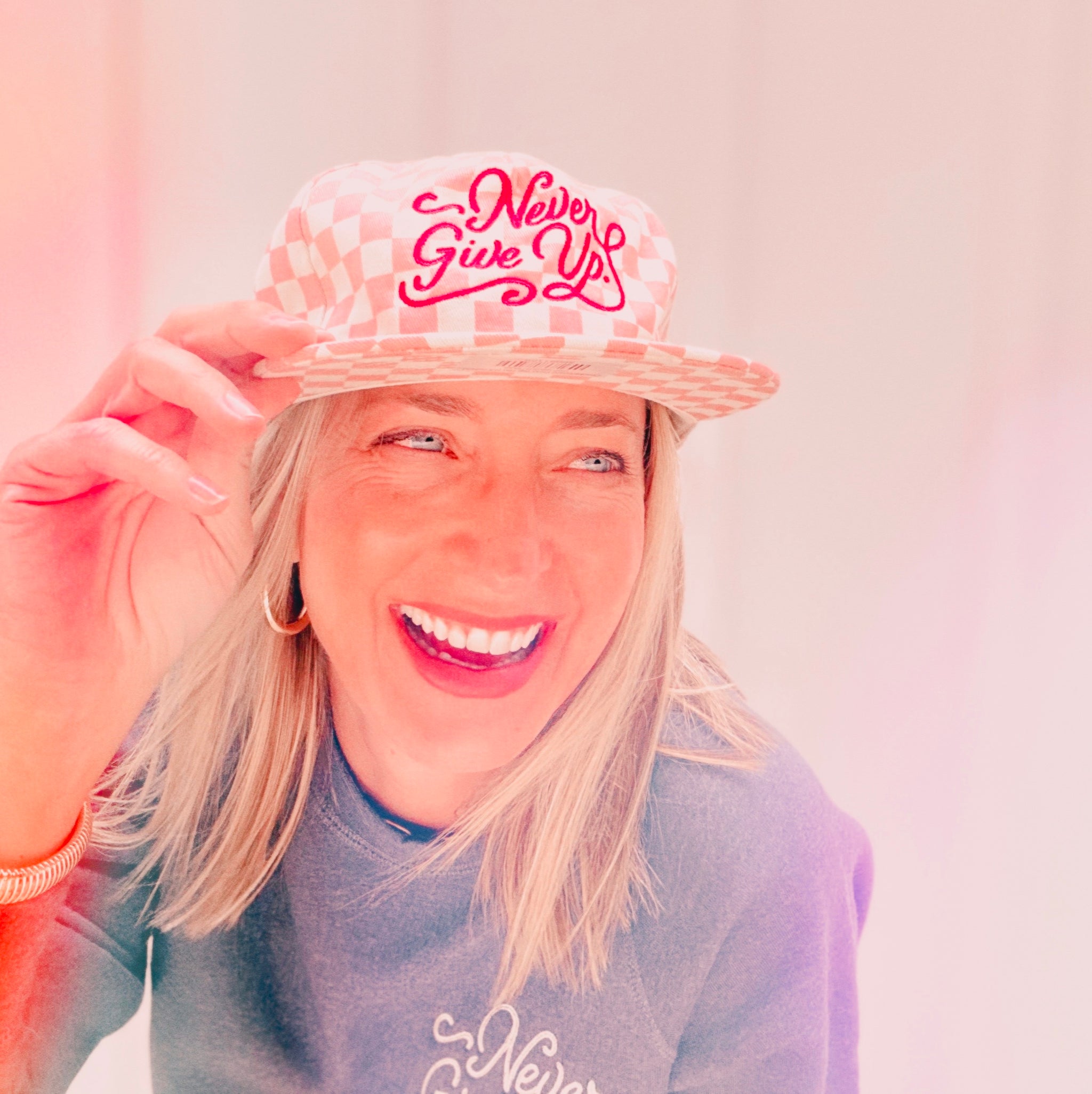 NEVER GIVE UP. PINK CHECKERED HAT
