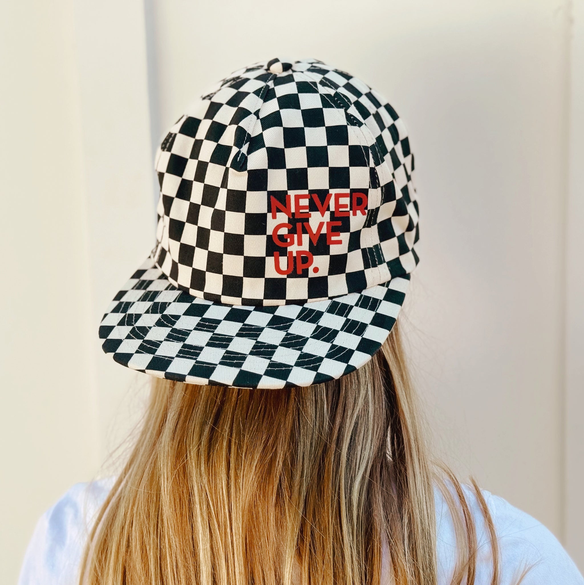 NEVER GIVE UP. BLACK CHECKERED HAT