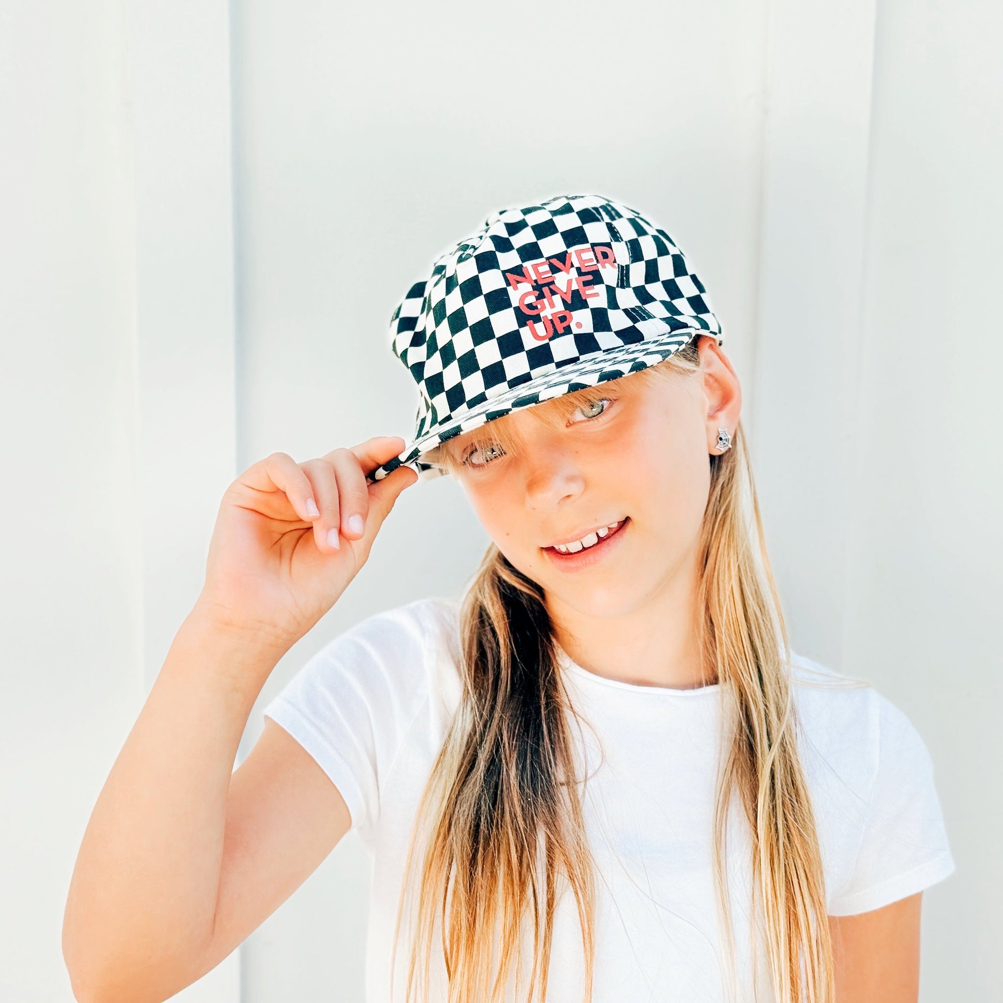 NEVER GIVE UP. BLACK CHECKERED HAT