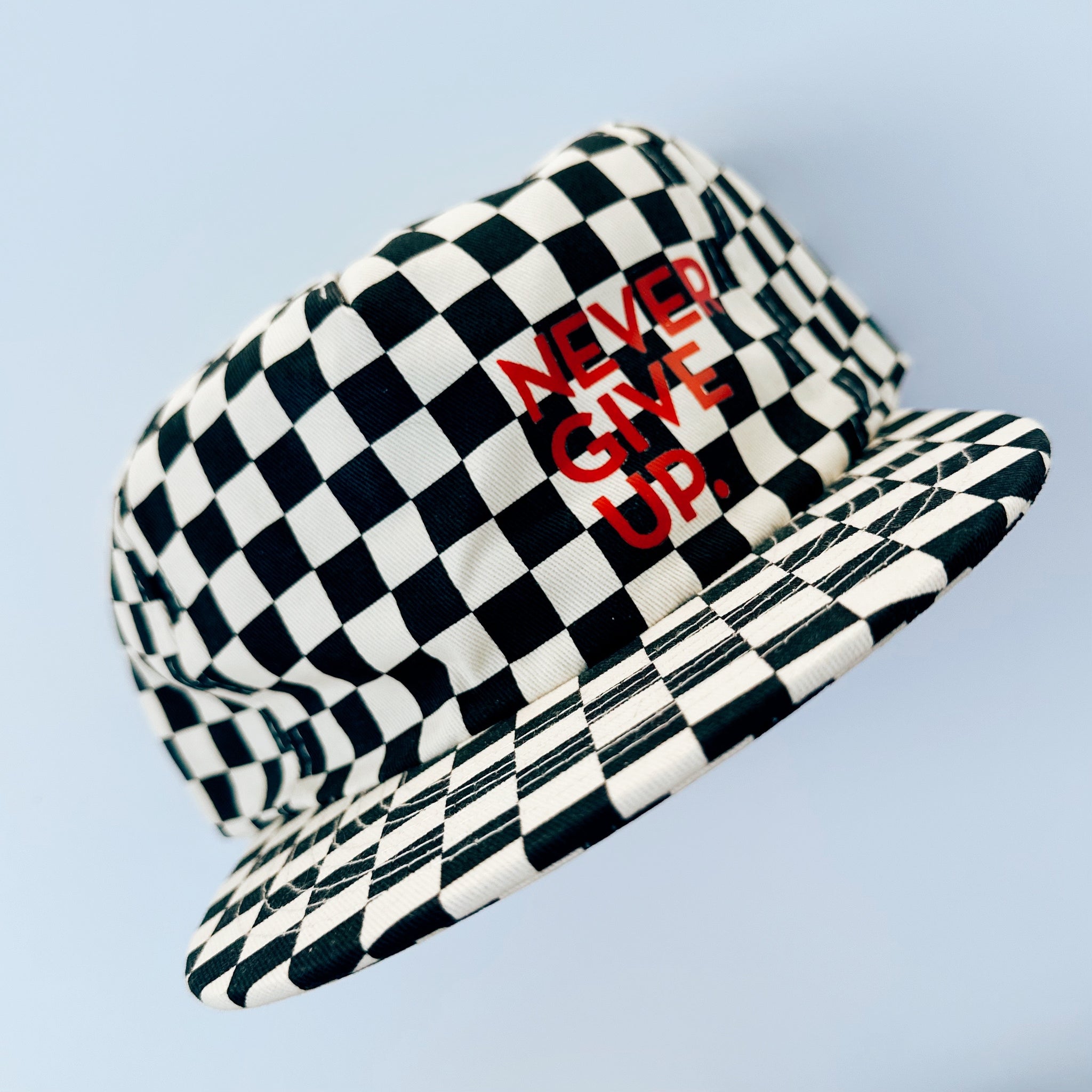 NEVER GIVE UP. BLACK CHECKERED HAT