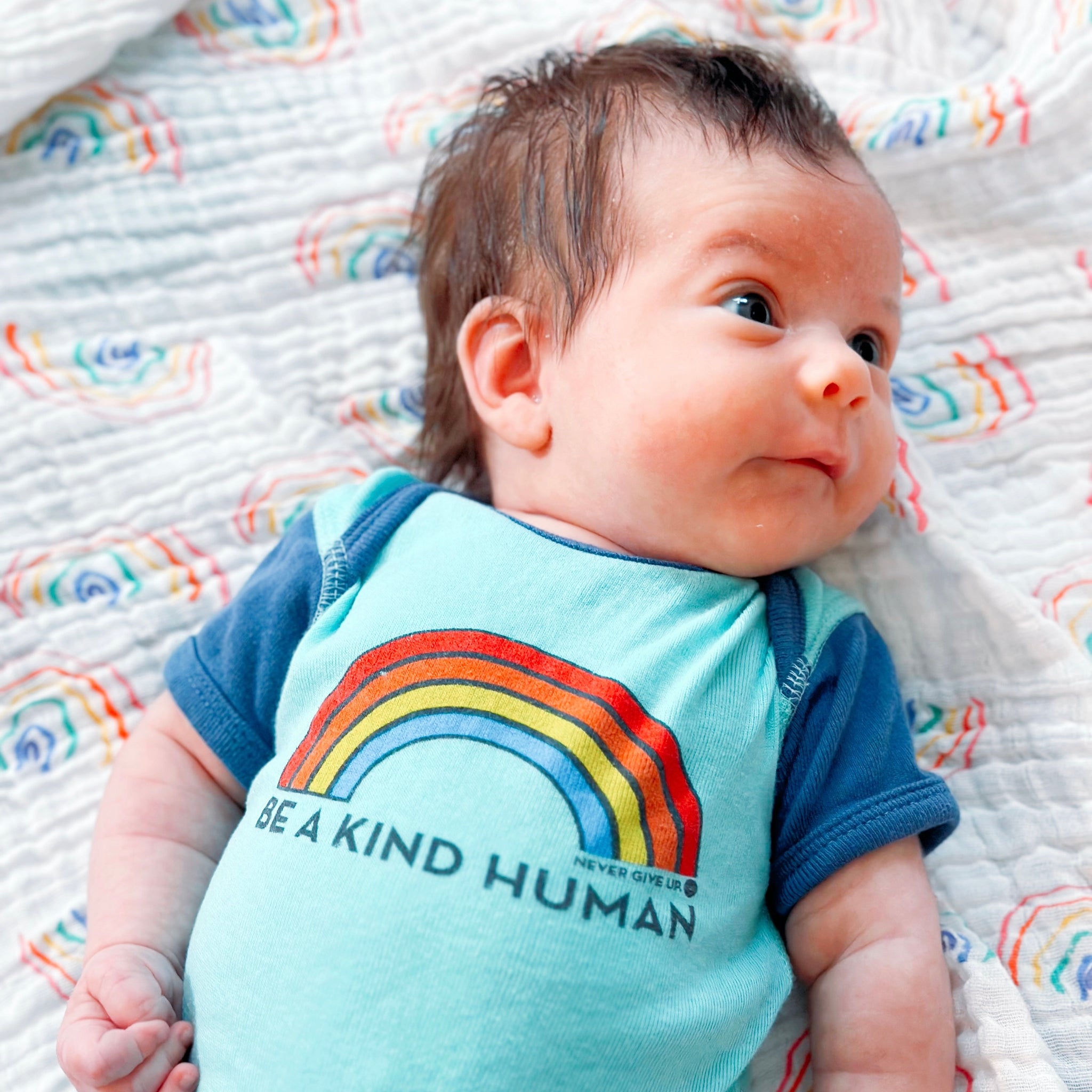 BE A KIND HUMAN BRIGHT RAINBOW ONESIE