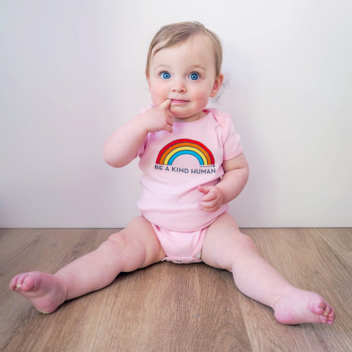 BE A KIND HUMAN BRIGHT RAINBOW ONESIE