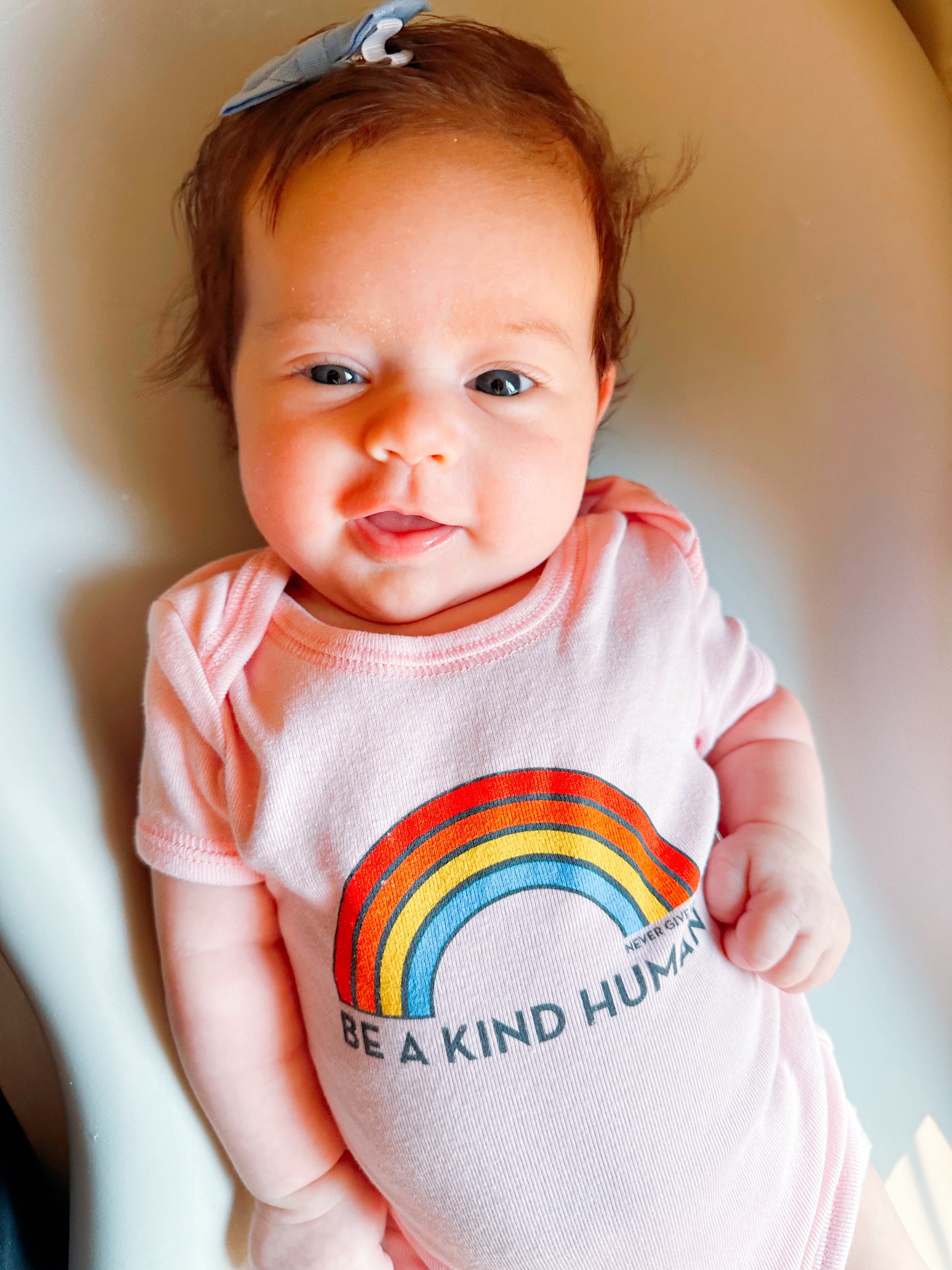 BE A KIND HUMAN BRIGHT RAINBOW ONESIE