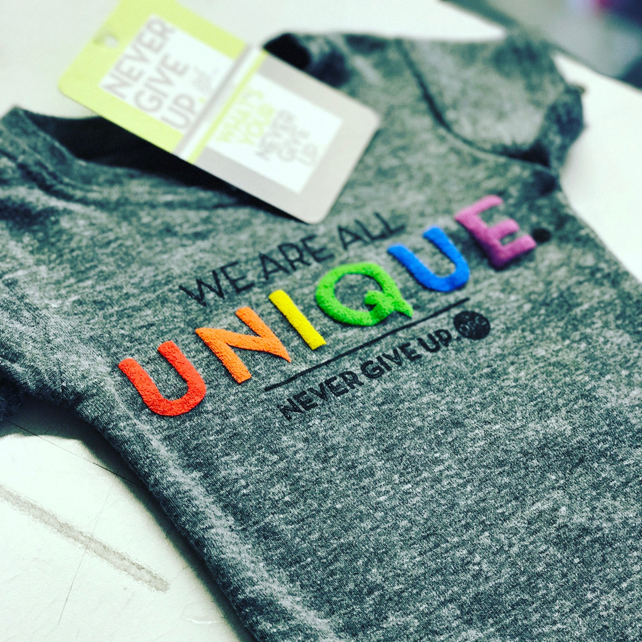 BABY WE ARE ALL UNIQUE ONESIE