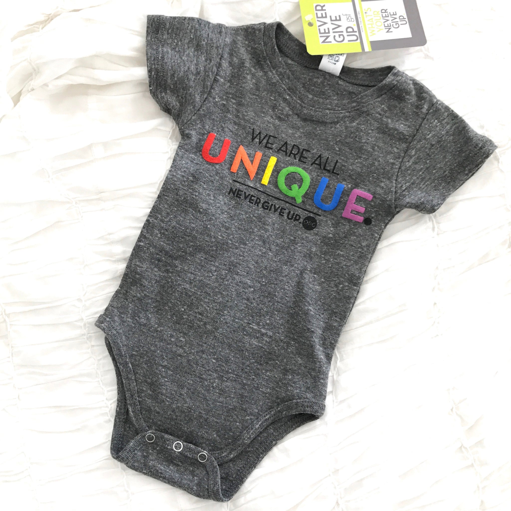 BABY WE ARE ALL UNIQUE ONESIE
