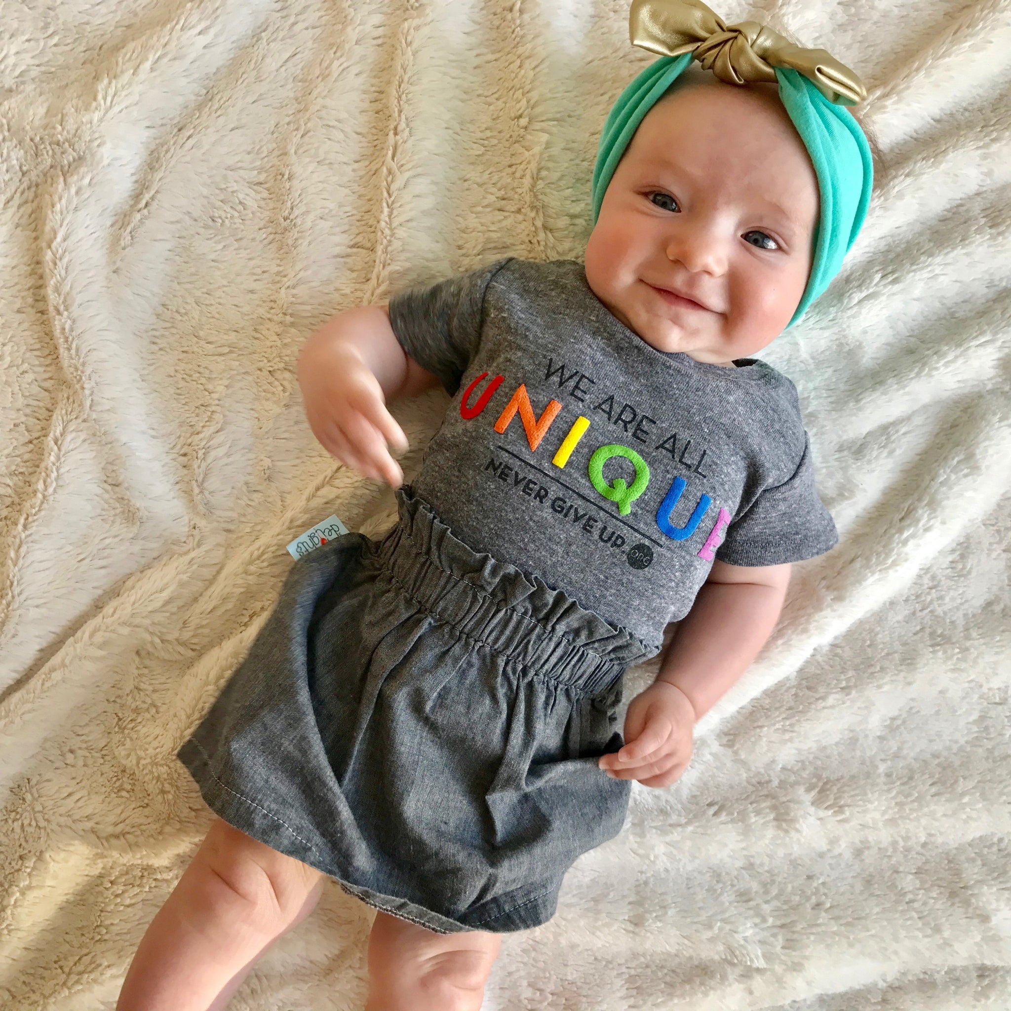 BABY WE ARE ALL UNIQUE ONESIE