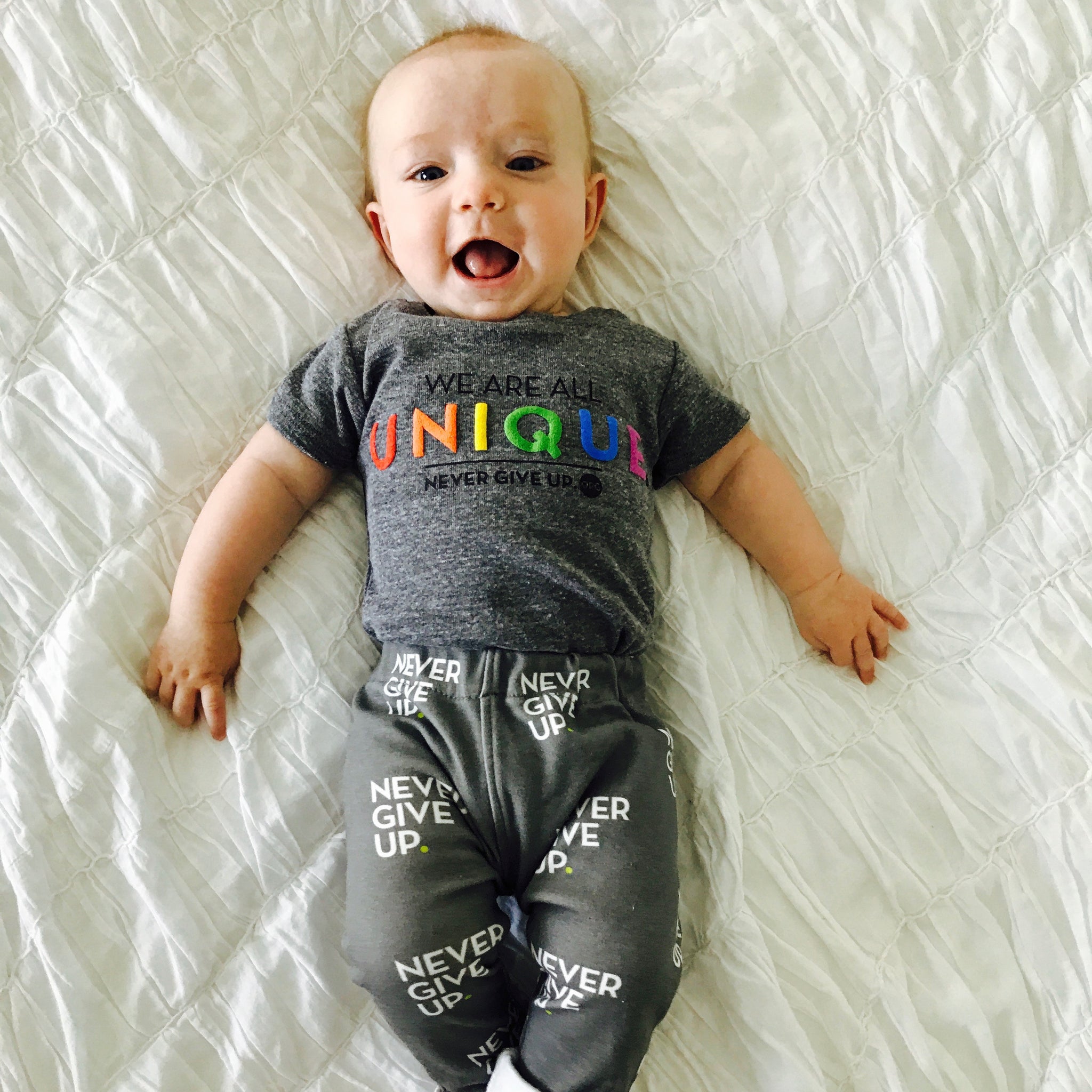 BABY WE ARE ALL UNIQUE ONESIE