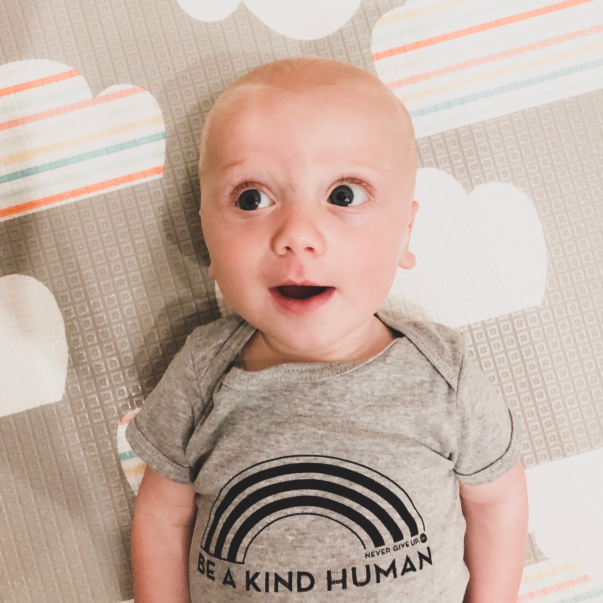 BE A KIND HUMAN BABY ONESIE