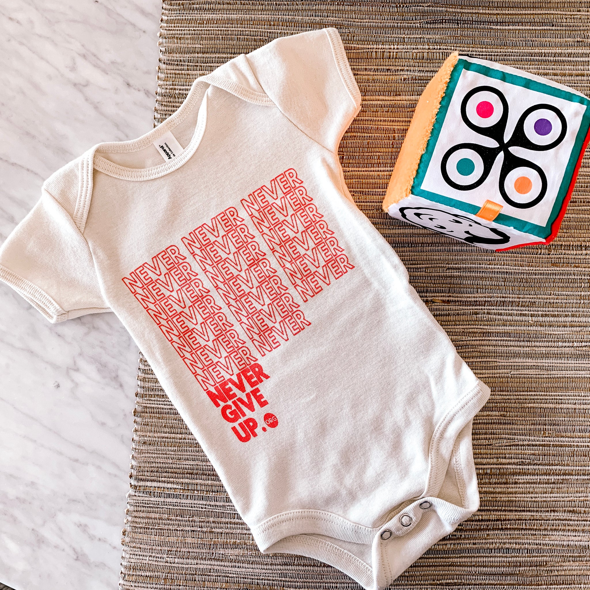 BABY INFINITE NEVER GIVE UP. ONESIE