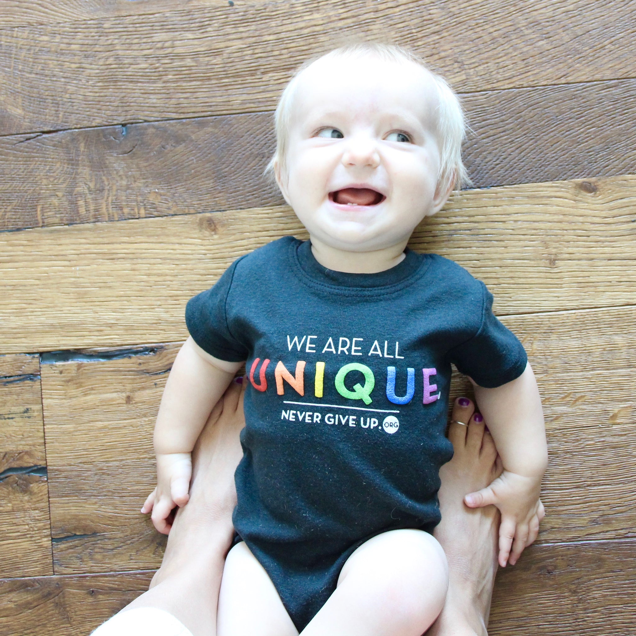 BABY WE ARE ALL UNIQUE ONESIE