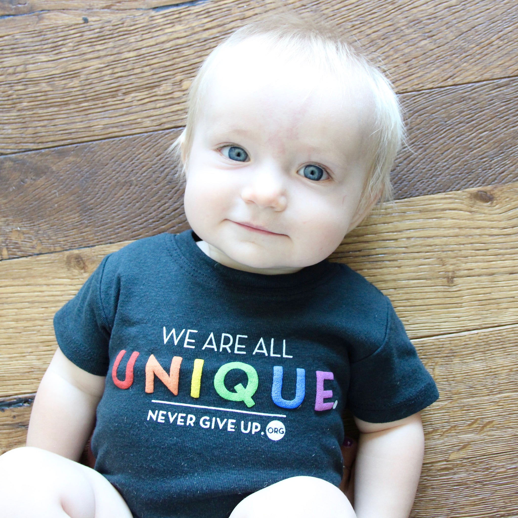 BABY WE ARE ALL UNIQUE ONESIE