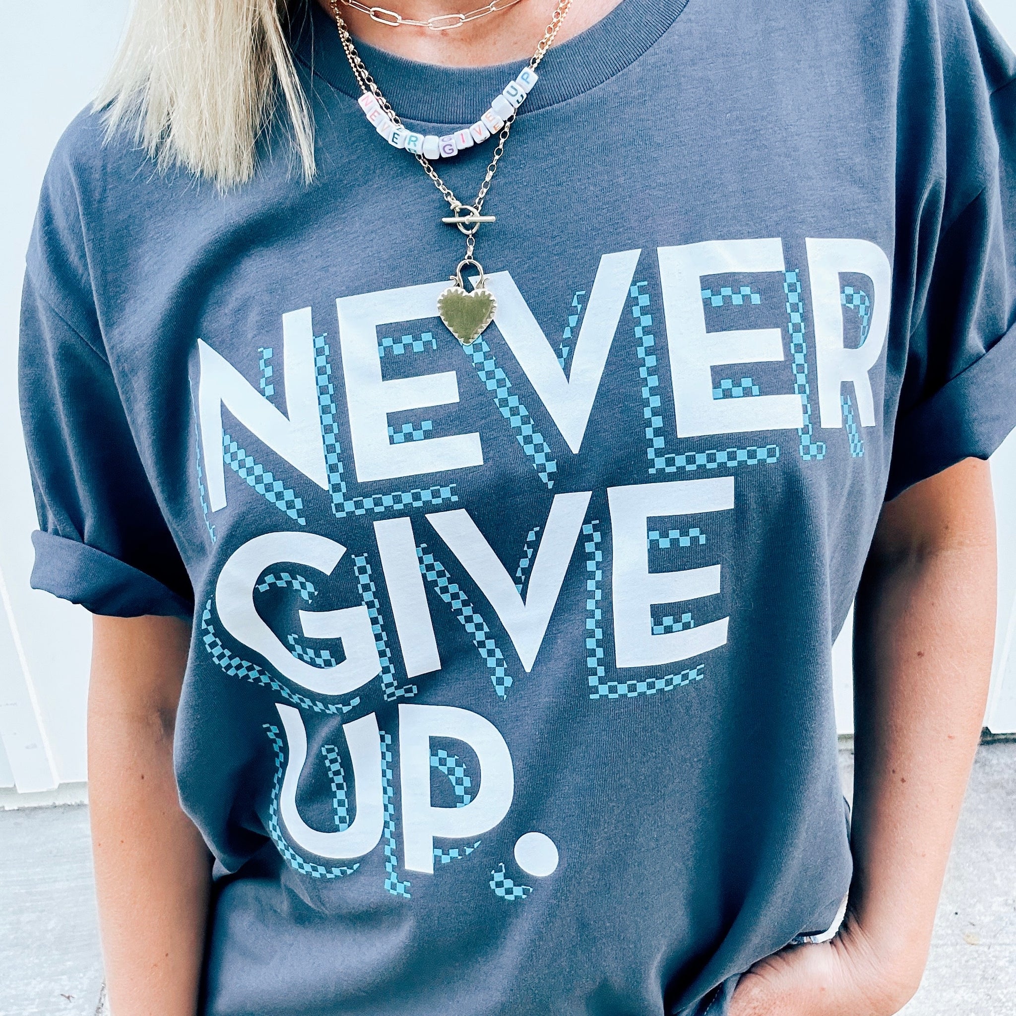 CHECKERBOARD NEVER GIVE UP. TEE