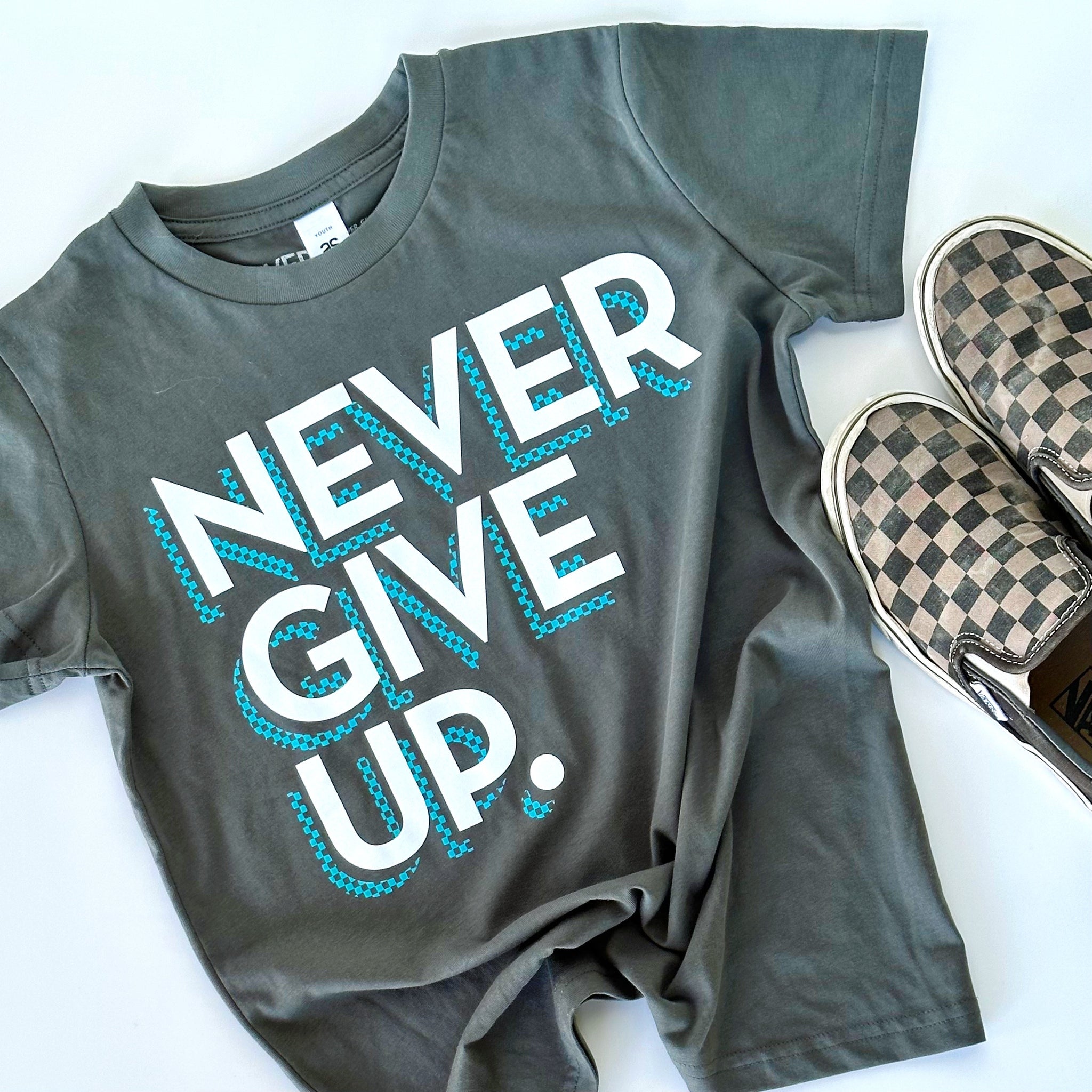 CHECKERBOARD NEVER GIVE UP. TEE