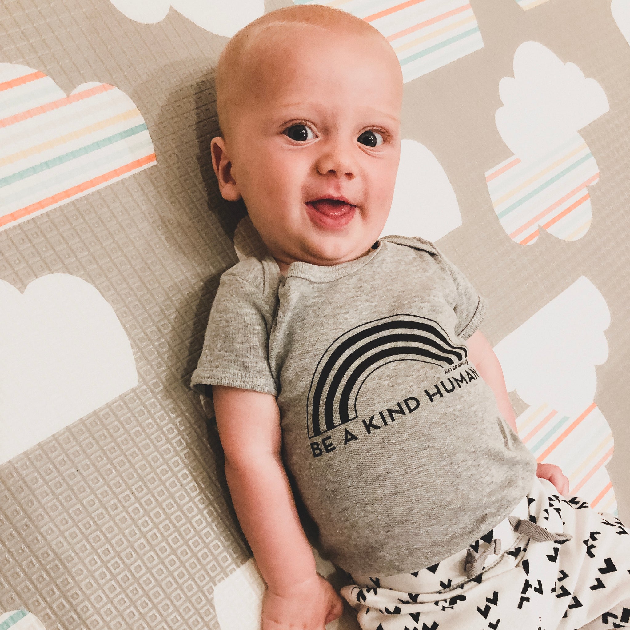 BE A KIND HUMAN BABY ONESIE